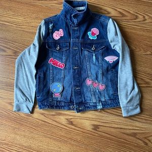 Medium distressed denim jacket with some distress rips. New